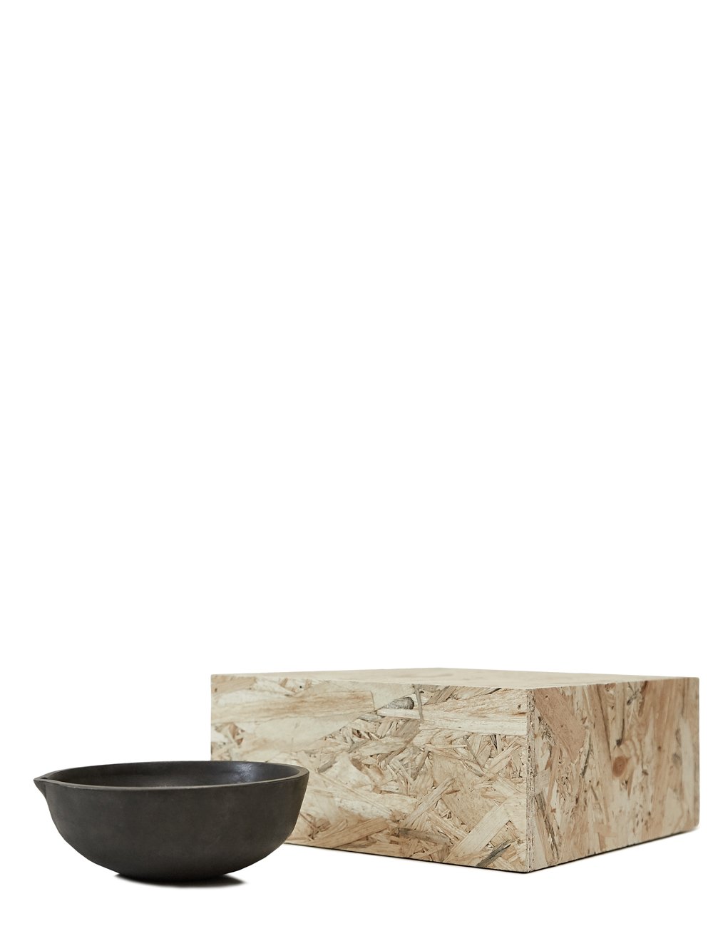 RICK OWENS BOWL HAS A ROUND SHAPE AND FEATURES A SMALL TRIANGLE DETAIL AND POLISHED SURFACE.